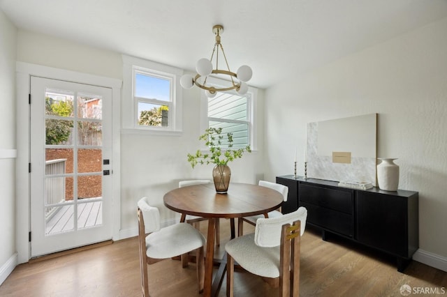 dining area with an inviting chandelier and light wood-type flooring