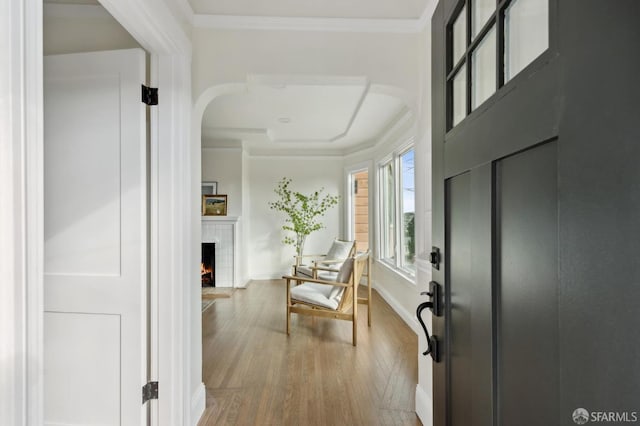 hall featuring ornamental molding and hardwood / wood-style floors