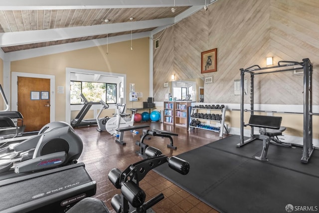 workout area featuring high vaulted ceiling, wooden ceiling, and wood walls