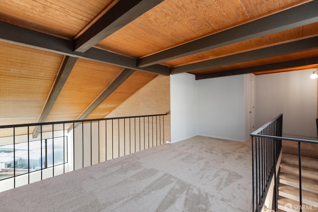 interior space with vaulted ceiling with beams, wood ceiling, and carpet flooring