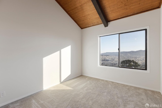 empty room featuring baseboards, wood ceiling, vaulted ceiling with beams, carpet floors, and a mountain view