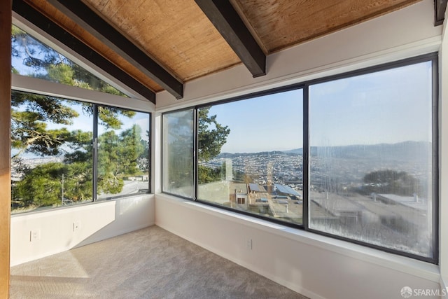 unfurnished sunroom with vaulted ceiling with beams and wood ceiling