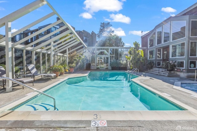 view of pool featuring a lanai and a patio area