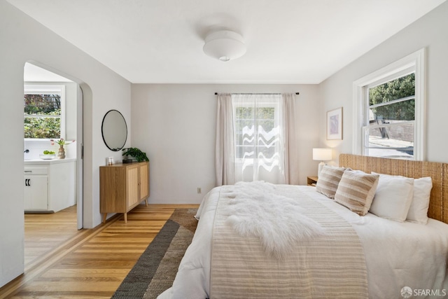 600 Ellsworth St, San Francisco, CA 94110 - bedroom featuring multiple windows and light wood-style floors