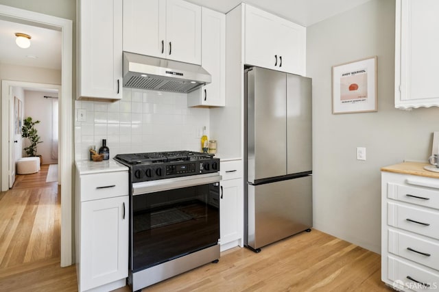 600 Ellsworth St, San Francisco, CA 94110 - kitchen featuring stainless steel appliances, under cabinet range hood, light countertops, decorative backsplash, and white cabinetry