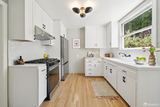 600 Ellsworth St, San Francisco, CA 94110 - kitchen with under cabinet range hood, stainless steel appliances, tasteful backsplash, and light countertops