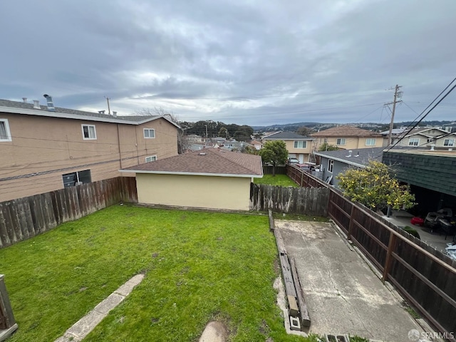 view of yard with a fenced backyard and a residential view