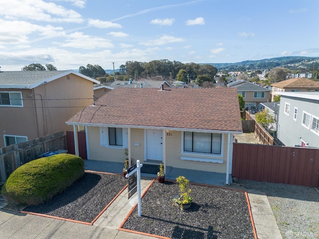 single story home with roof with shingles, a residential view, and fence