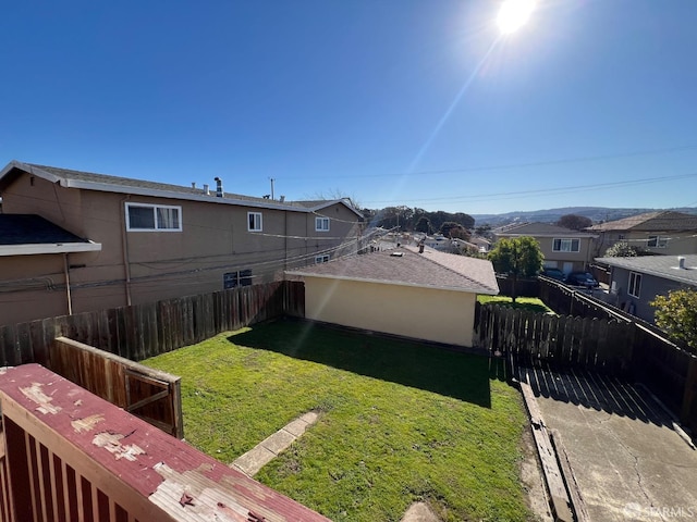 view of yard with a fenced backyard and a residential view