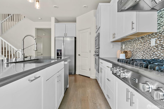382 Crestview Cir, Daly City, CA 94015 - kitchen featuring exhaust hood, dark countertops, and white cabinets