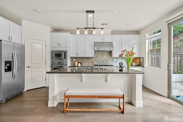382 Crestview Cir, Daly City, CA 94015 - kitchen featuring appliances with stainless steel finishes, under cabinet range hood, tasteful backsplash, light wood-style floors, and white cabinets