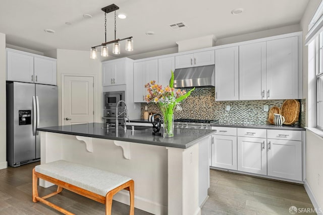 382 Crestview Cir, Daly City, CA 94015 - kitchen featuring stainless steel appliances, under cabinet range hood, dark countertops, light wood-style floors, and recessed lighting