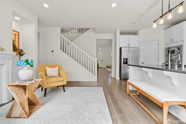 382 Crestview Cir, Daly City, CA 94015 - kitchen with stainless steel appliances, dark countertops, light wood-style floors, white cabinetry, and recessed lighting