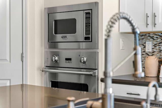 382 Crestview Cir, Daly City, CA 94015 - kitchen view of appliances with stainless steel finishes, tasteful backsplash, and white cabinetry