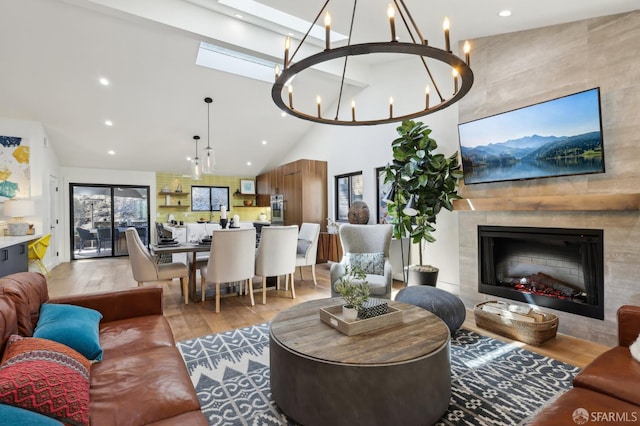 2031 Buena Vista Dr, Pinole, CA 94564 - living room featuring light wood-style flooring, high vaulted ceiling, a chandelier, a tiled fireplace, and recessed lighting