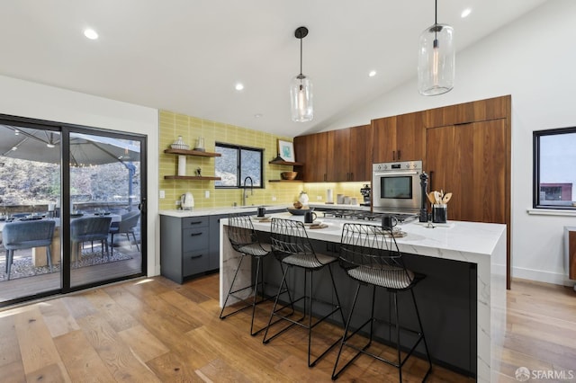 2031 Buena Vista Dr, Pinole, CA 94564 - kitchen with stainless steel appliances, open shelves, light wood-style flooring, decorative light fixtures, and vaulted ceiling