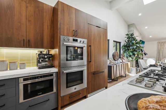 2031 Buena Vista Dr, Pinole, CA 94564 - kitchen featuring appliances with stainless steel finishes, modern cabinets, beamed ceiling, light stone countertops, and light wood-style floors