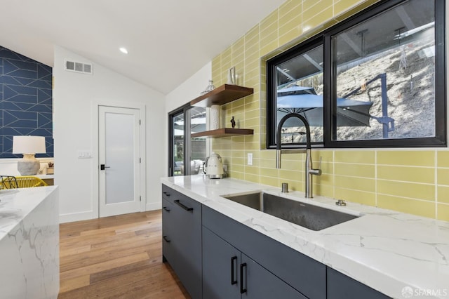 2031 Buena Vista Dr, Pinole, CA 94564 - kitchen with a sink, lofted ceiling, light wood-type flooring, backsplash, and open shelves
