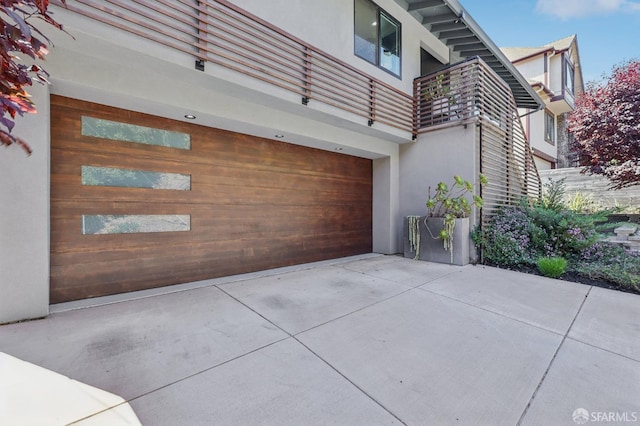 2031 Buena Vista Dr, Pinole, CA 94564 - view of property exterior featuring stucco siding, a garage, a balcony, and driveway