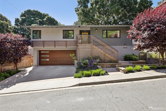 2031 Buena Vista Dr, Pinole, CA 94564 - view of front facade featuring stucco siding, a garage, driveway, and stairs