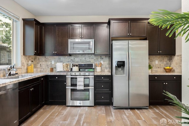 192 Montevina Way, Hayward, CA 94545 - kitchen with appliances with stainless steel finishes, a sink, dark brown cabinetry, and light stone countertops