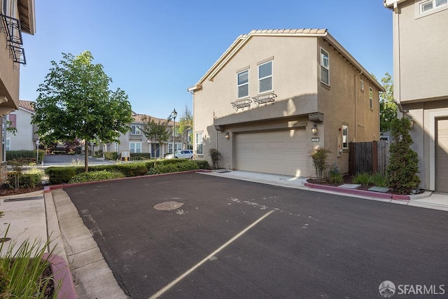 192 Montevina Way, Hayward, CA 94545 - view of front of property featuring an attached garage, stucco siding, a residential view, and asphalt driveway