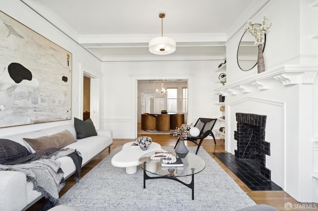 living room featuring a chandelier, dark hardwood / wood-style flooring, and crown molding