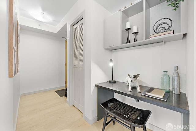 hall featuring wood finished floors and baseboards