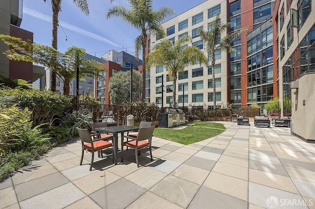 view of patio featuring outdoor dining space and fence