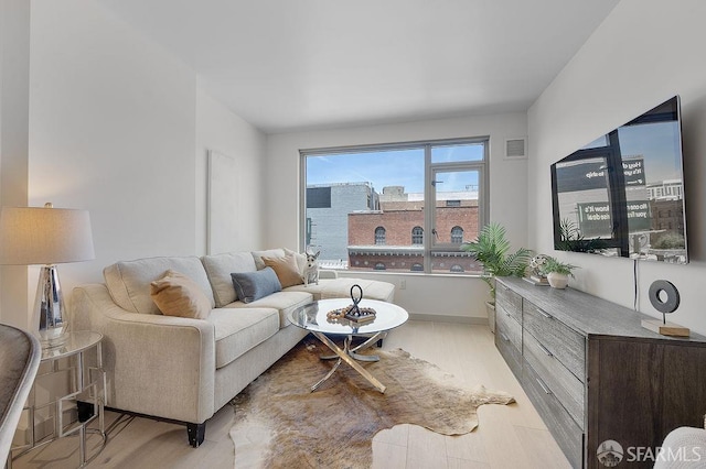 living room with wood finished floors and baseboards