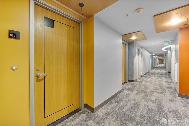 hallway with light carpet and baseboards