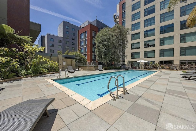 community pool with a patio area