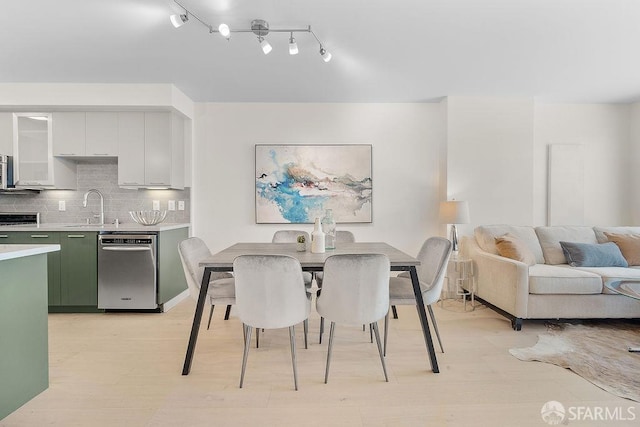 dining space featuring light wood finished floors