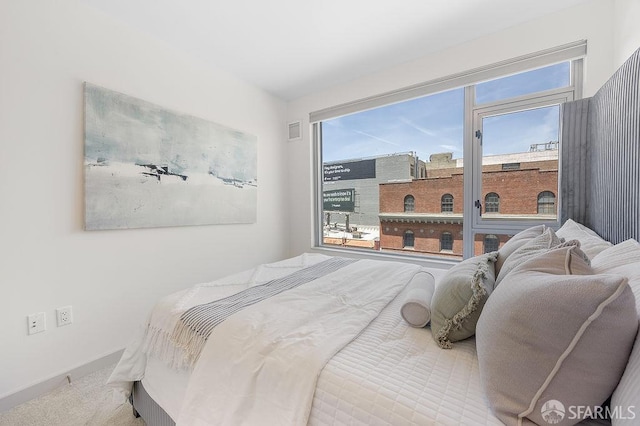 carpeted bedroom with baseboards