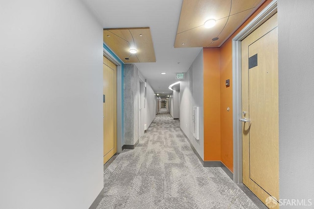 hall with light carpet and baseboards
