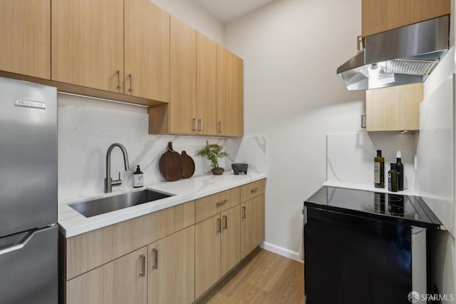 kitchen featuring ventilation hood, backsplash, light brown cabinetry, and stainless steel refrigerator