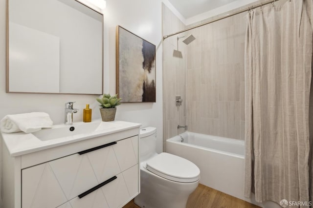 full bathroom featuring vanity, toilet, hardwood / wood-style floors, and shower / bath combo with shower curtain