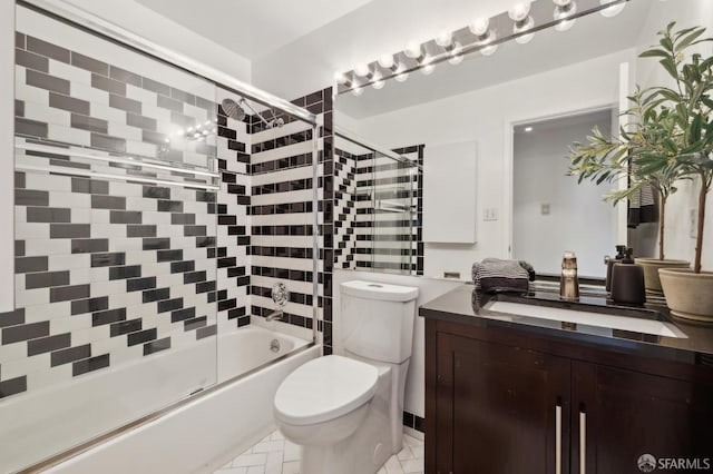 full bathroom with vanity, combined bath / shower with glass door, and toilet