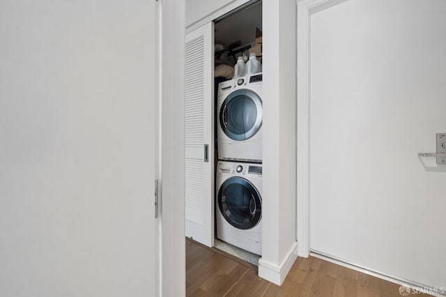723 Taylor St Unit 402, San Francisco, CA 94109 - laundry area featuring stacked washer / drying machine and wood finished floors
