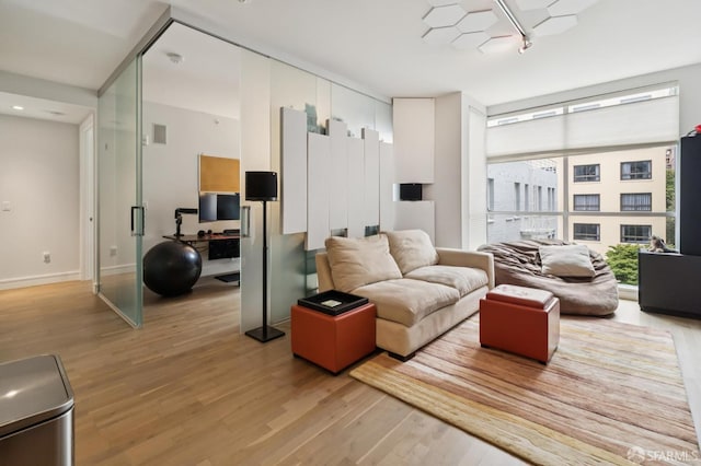 723 Taylor St Unit 402, San Francisco, CA 94109 - living area featuring light wood finished floors and rail lighting