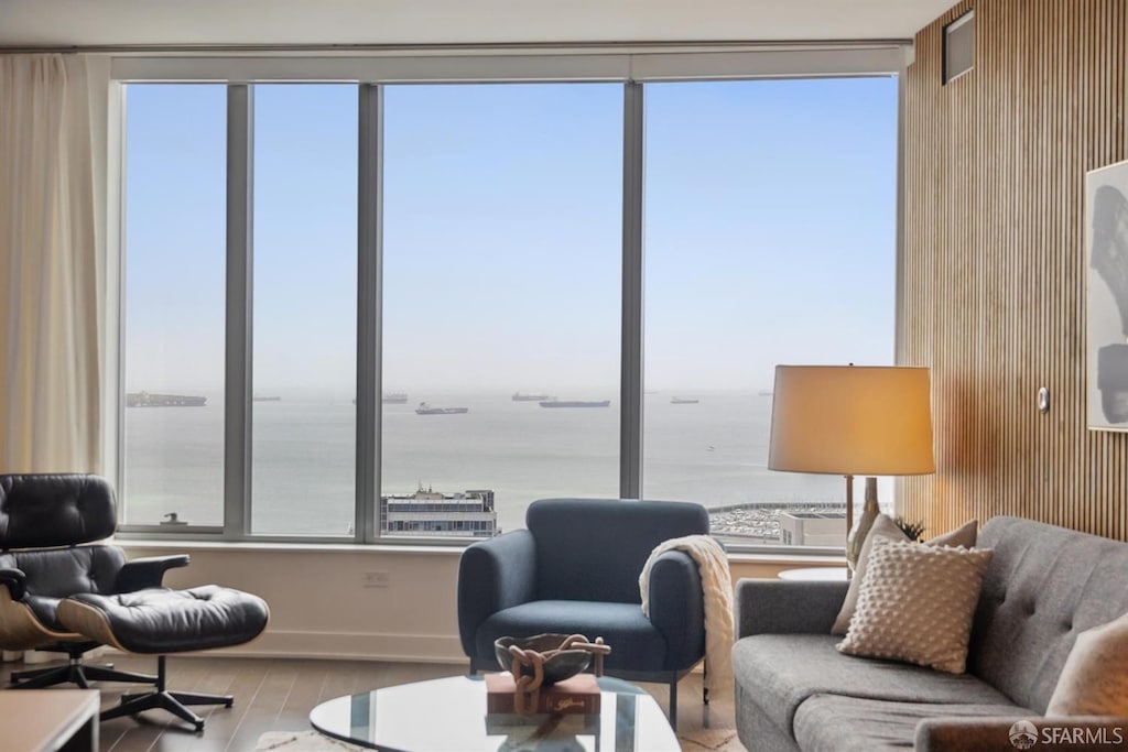 201 Folsom St Unit 34D, San Francisco, CA 94105 - living area featuring a water view, baseboards, wood finished floors, and plenty of natural light
