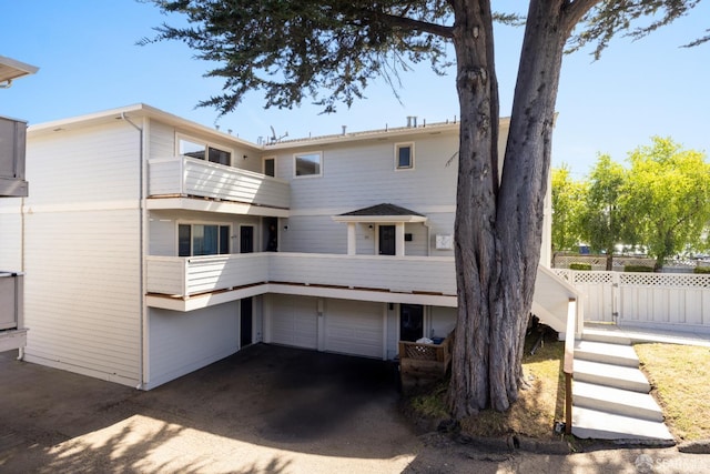 457-461 Cypress Ave, Half Moon Bay, CA 94019 - back of house featuring driveway, a balcony, and a garage
