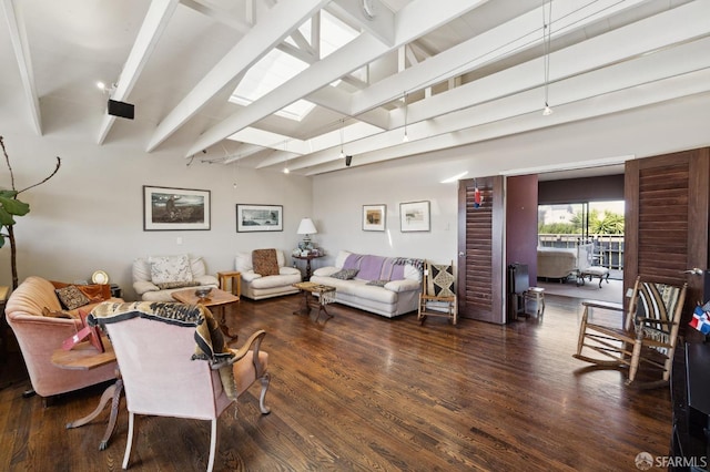 living room with a skylight, beamed ceiling, and dark hardwood / wood-style flooring