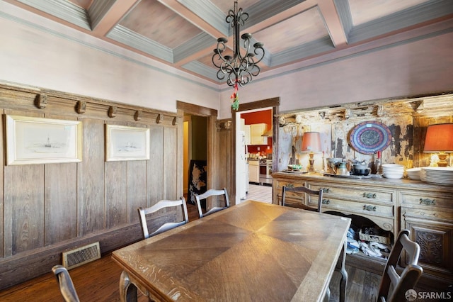 dining area with crown molding, coffered ceiling, beamed ceiling, and wood-type flooring