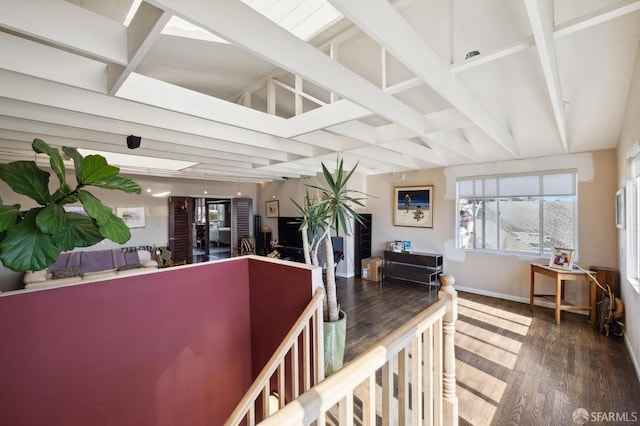 corridor with vaulted ceiling with beams and dark hardwood / wood-style floors