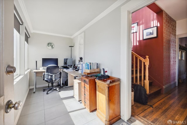 office space with built in desk, ornamental molding, and light tile patterned flooring