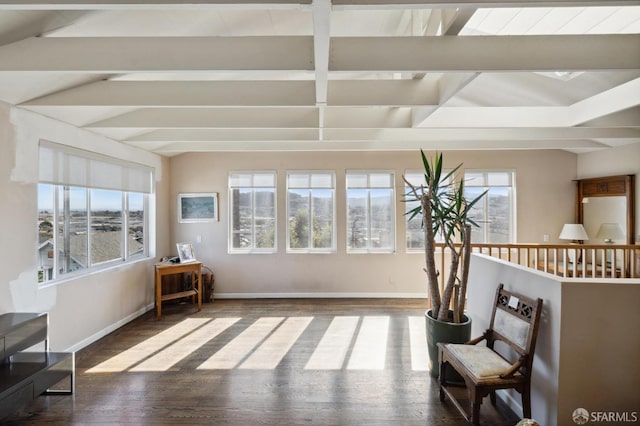 living area featuring hardwood / wood-style floors, lofted ceiling with beams, and plenty of natural light