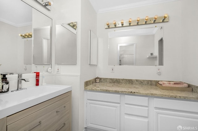 bathroom featuring vanity and ornamental molding