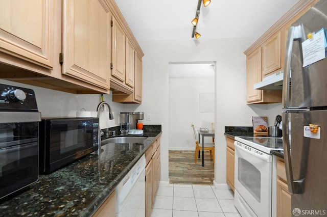 kitchen with black appliances, sink, light brown cabinets, track lighting, and dark stone counters