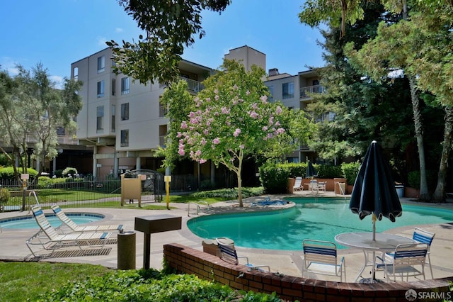 view of pool featuring a patio area and a hot tub